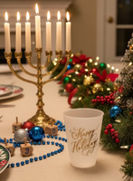 White ceramic tumbler with 'Happy Holidays' text in gold on a textured white background