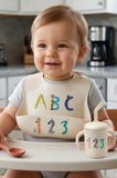 Sugarbooger Fresh & Messy Silicone Bib & Spoon Set in ABC123
